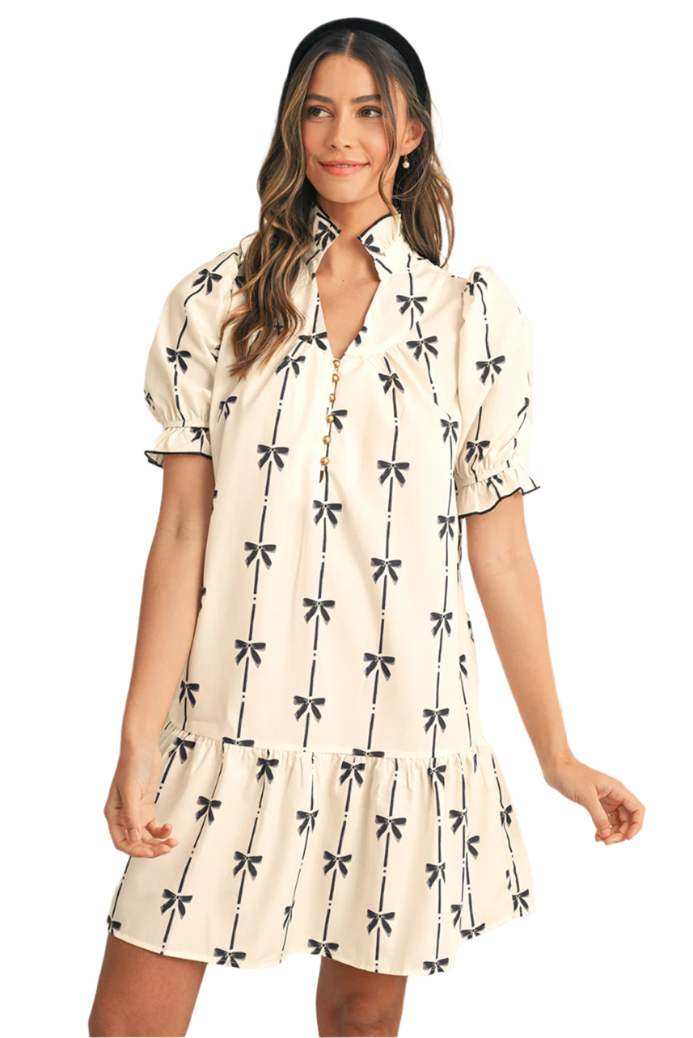 Front view of a trendy summer beige mini dress with a bow print, perfect for casual outings or beachwear.