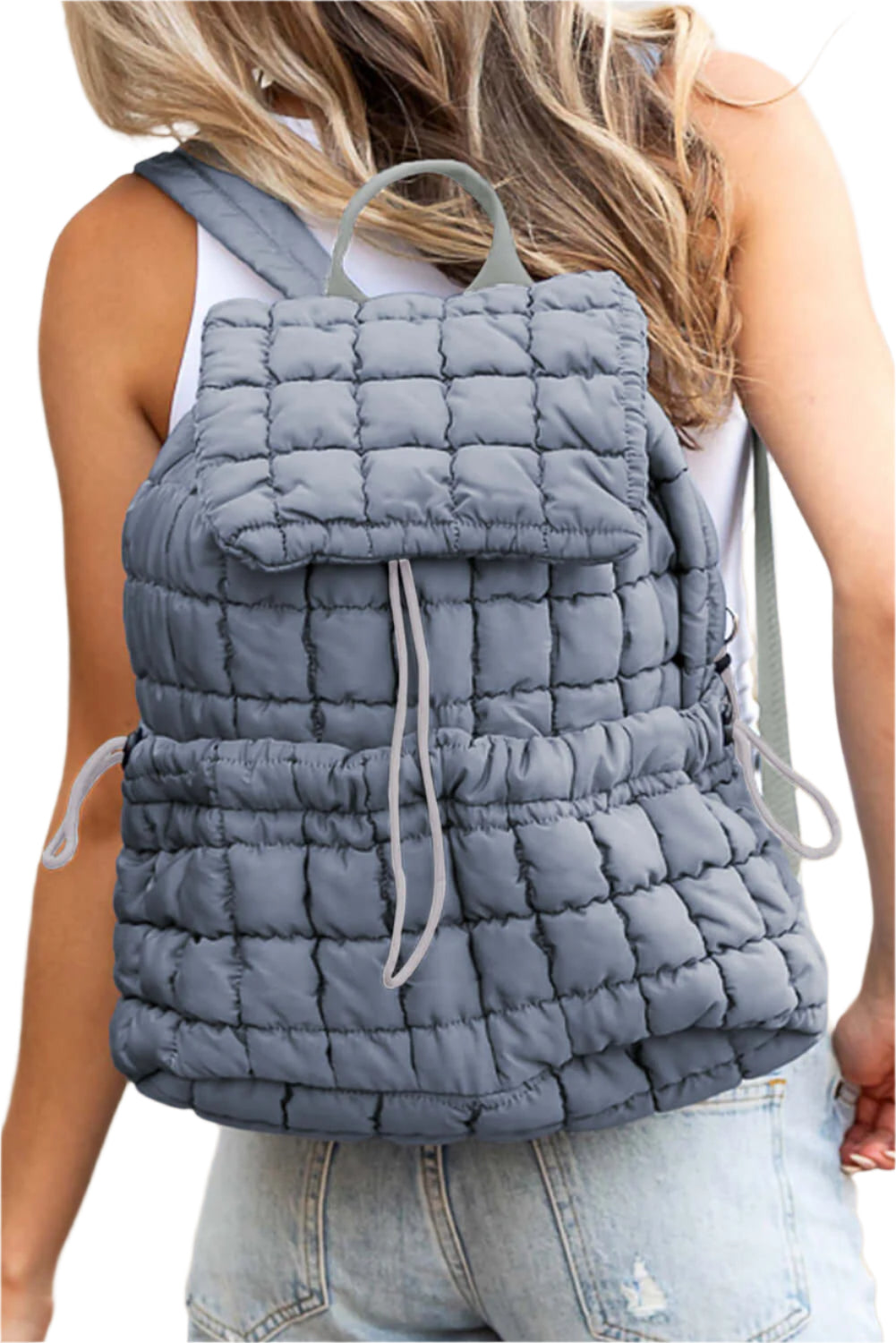 Blue quilted puffer backpack for women.