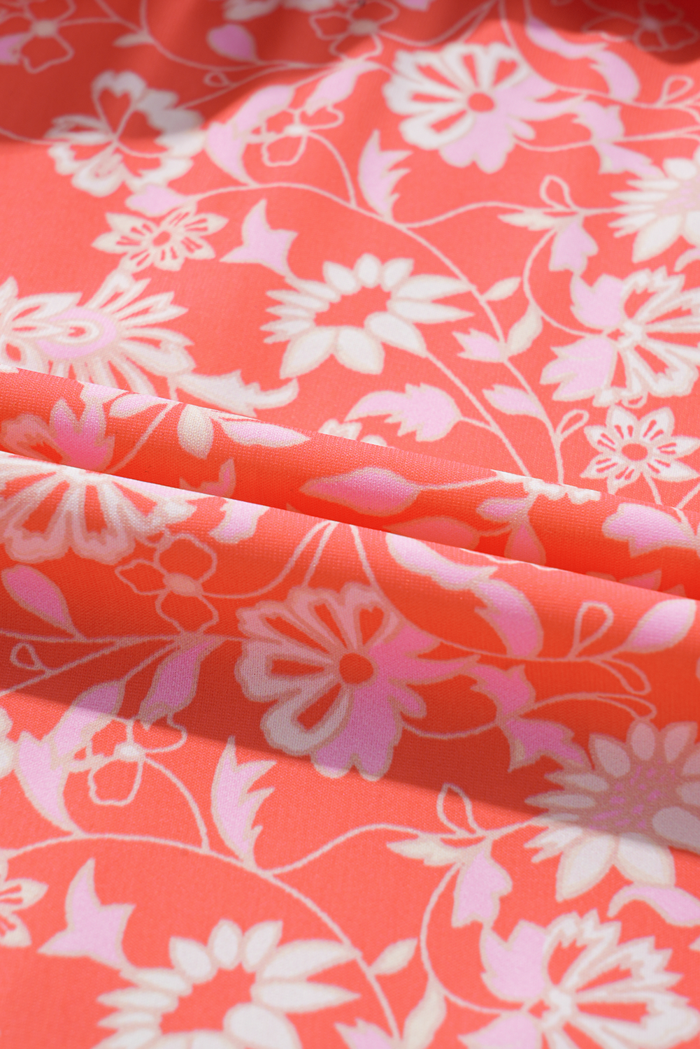 Fabric view of a red boho floral maxi dress with tie sleeves.