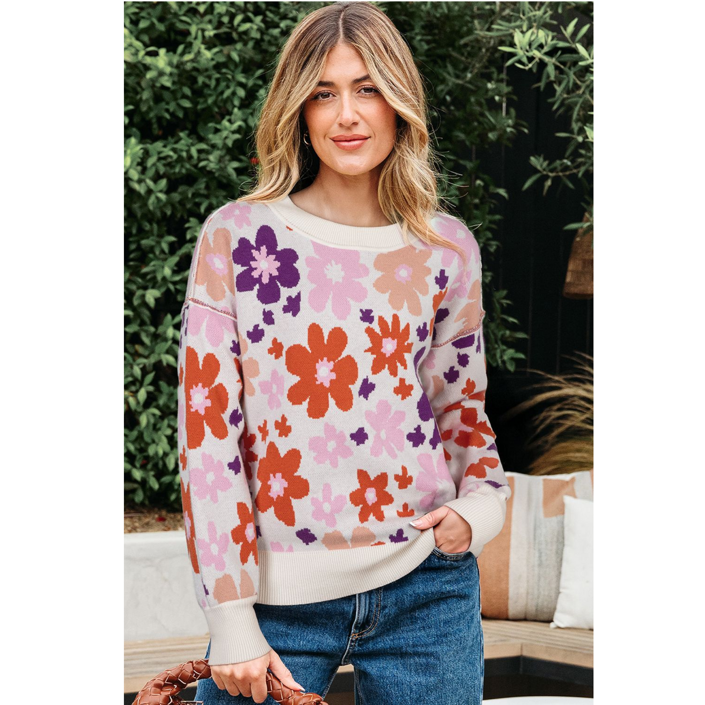 Woman wearing a colorful floral sweater outdoors