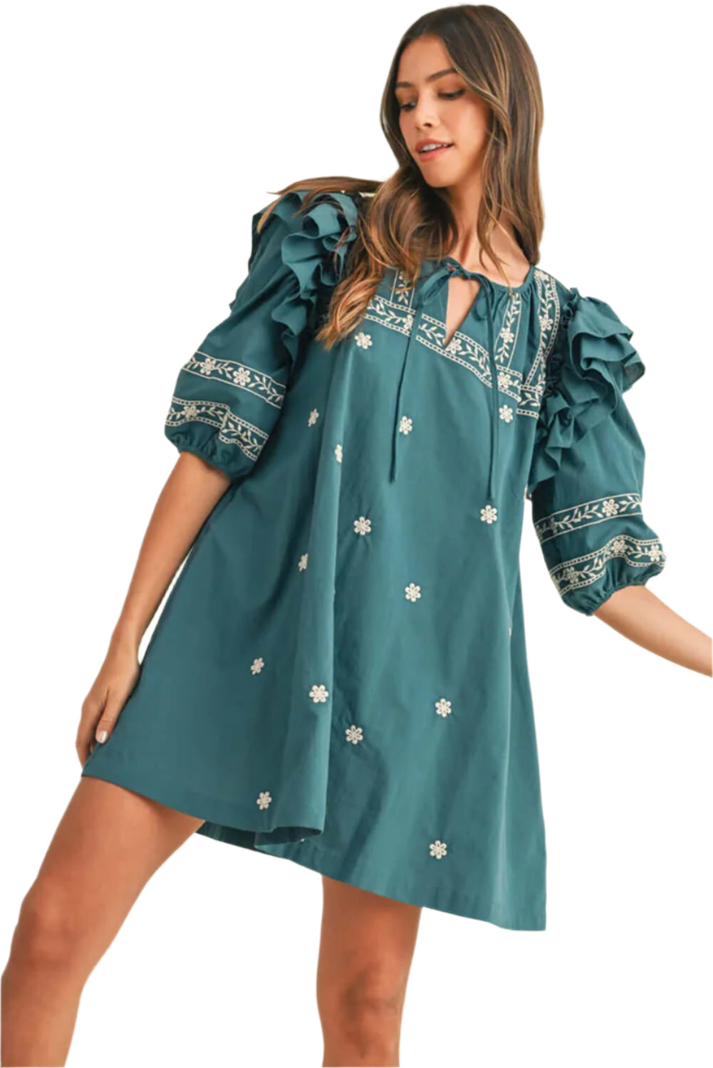 Woman wearing a teal boho mini dress with floral embroidery, puffed ruffle sleeves, and a tie-neck design, styled for a feminine and trendy look.