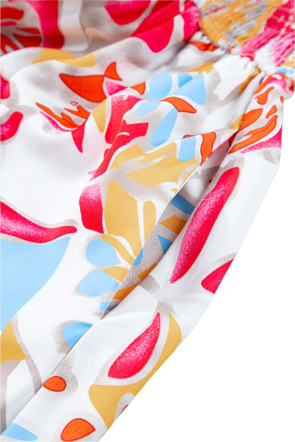 Pocket view of a rose red tropical midi dress with puff sleeves and smocked bodice.