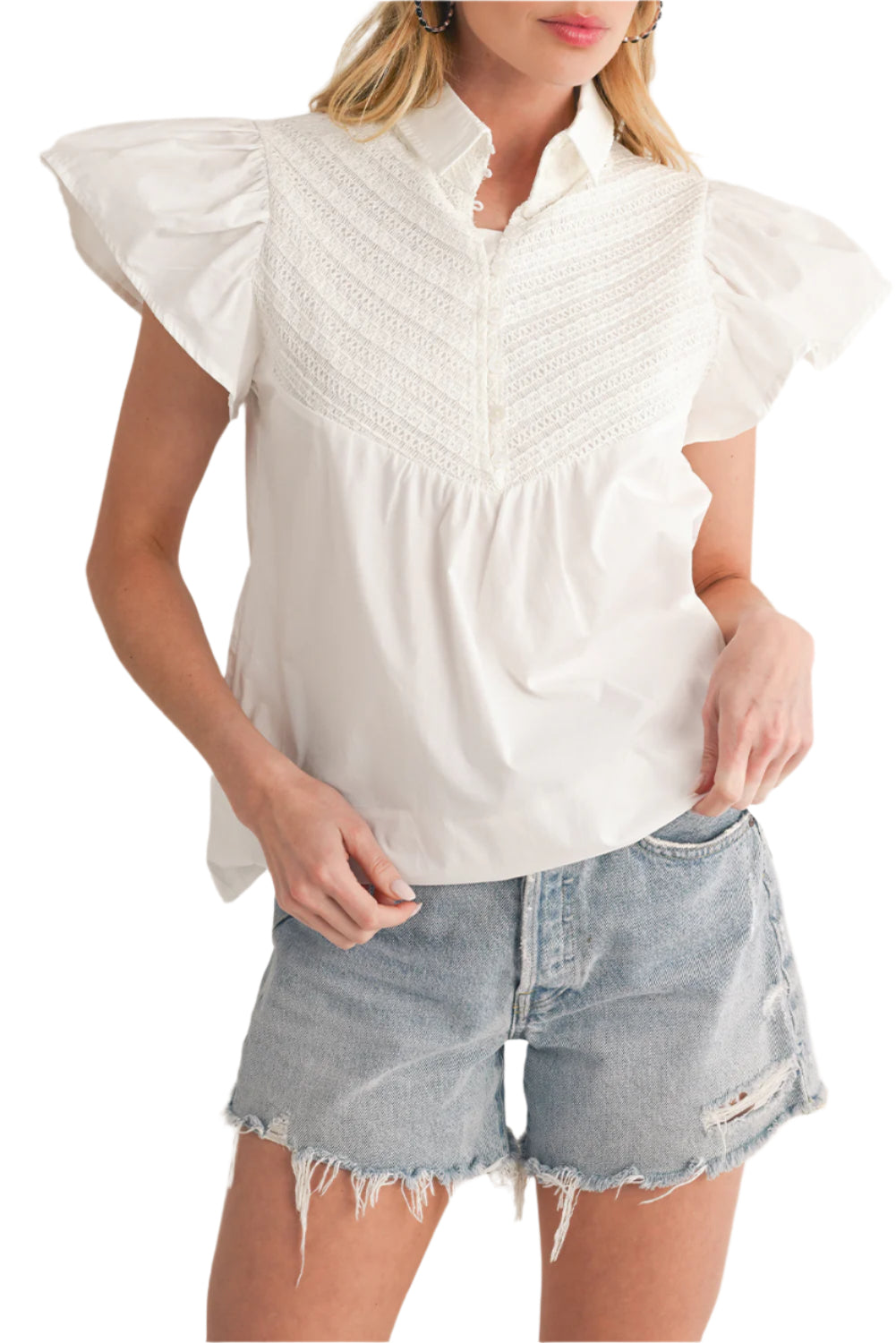 Women's white blouse with crochet patchwork and ruffle sleeves, perfect for summer style.