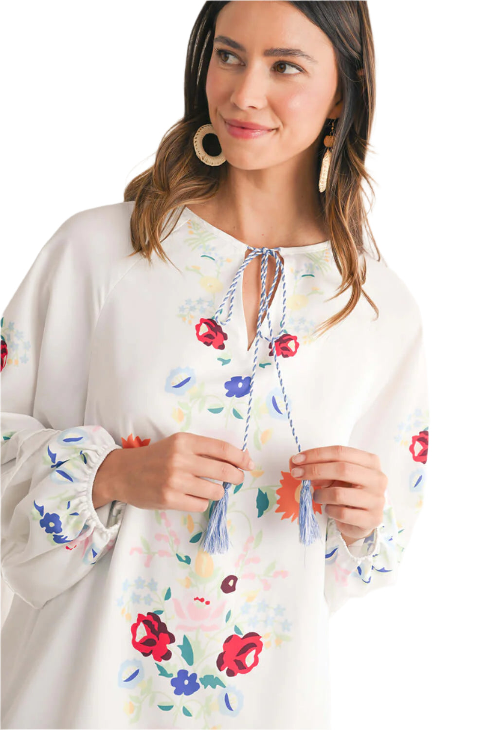 Focus half view of a white floral embroidered short dress with puff sleeves.