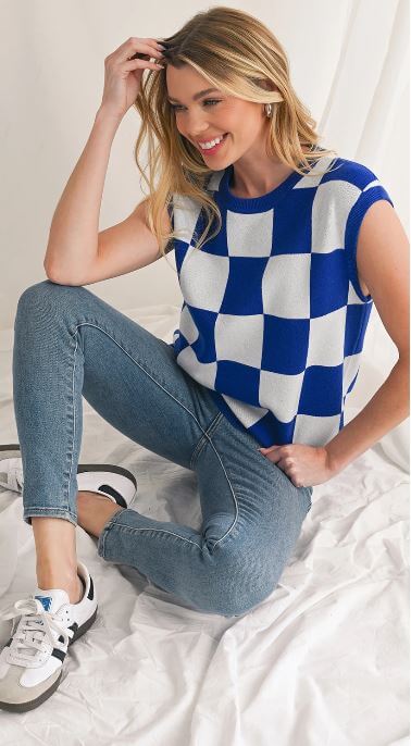 Model styling a checkered knit tank with minimal accessories for a chic look.