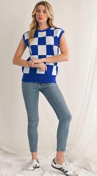 Casual outfit featuring a blue checkered sleeveless top and classic denim.