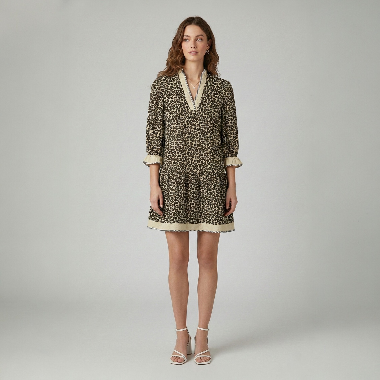 A model wearing a brown leopard print mini dress with ruffle sleeve details from the Catherine Martin casual dresses collection.