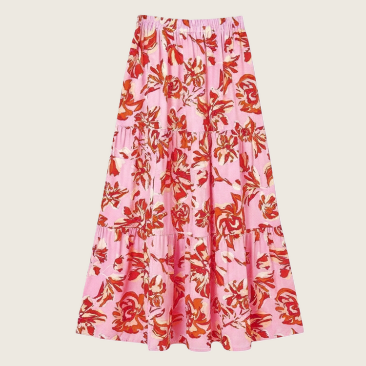 Person wearing a beige lace skirt and brown boots on a gray background