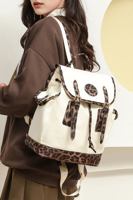Person wearing a white backpack with leopard print accents