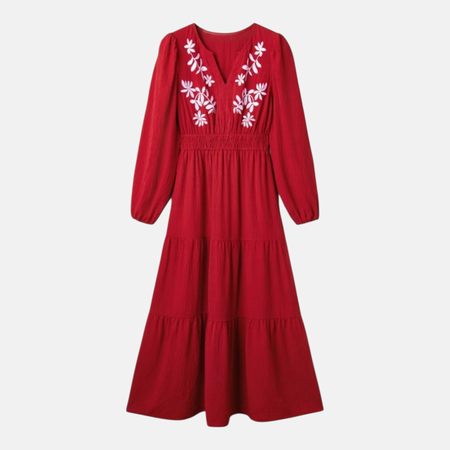 A flat-lay product image of the burgundy tiered maxi dress featuring intricate white floral contrast embroidery on the V-neck bodice and long balloon sleeves.