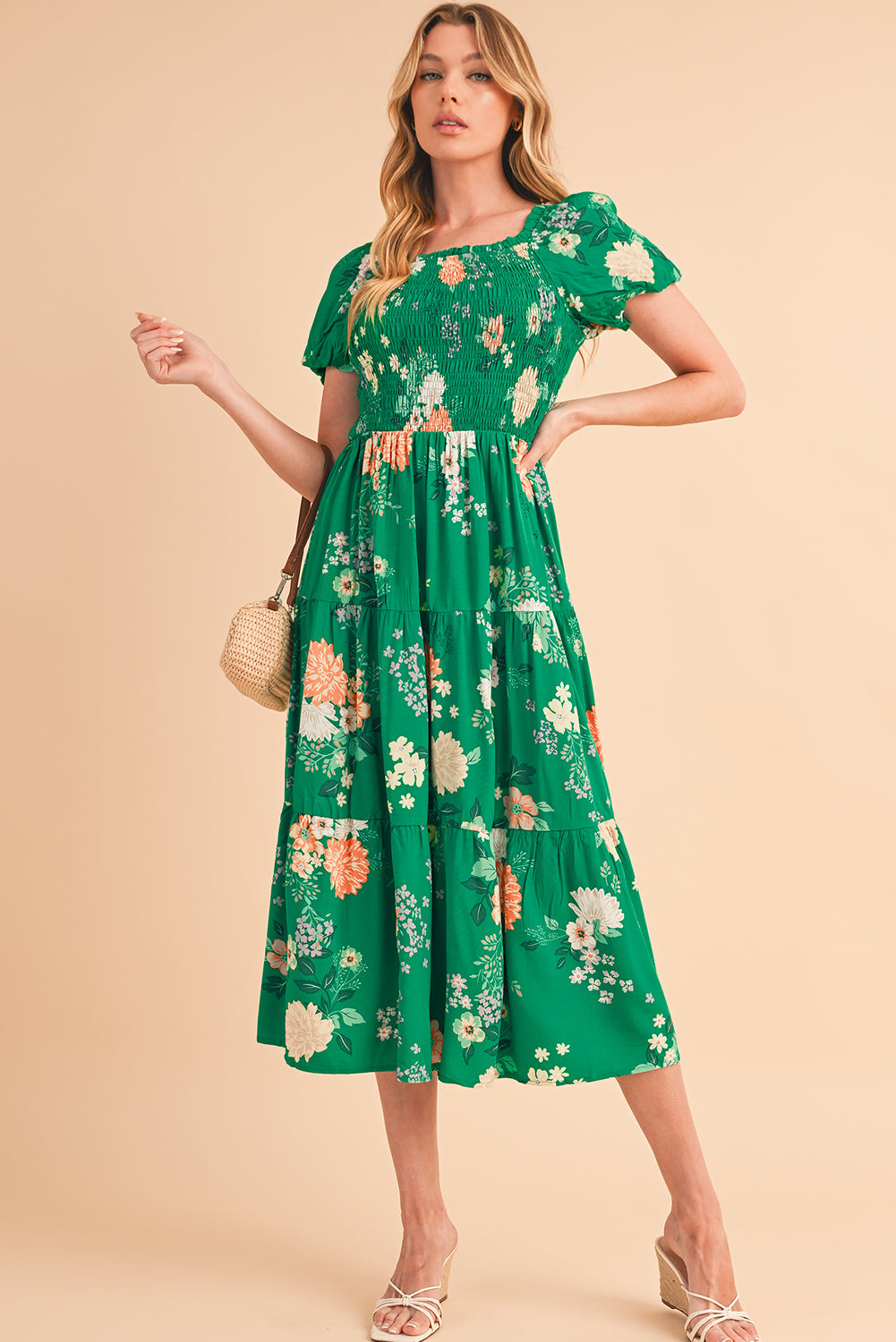 Full front view of a green floral midi dress with short bracelet sleeves, modeled for a stylish look.