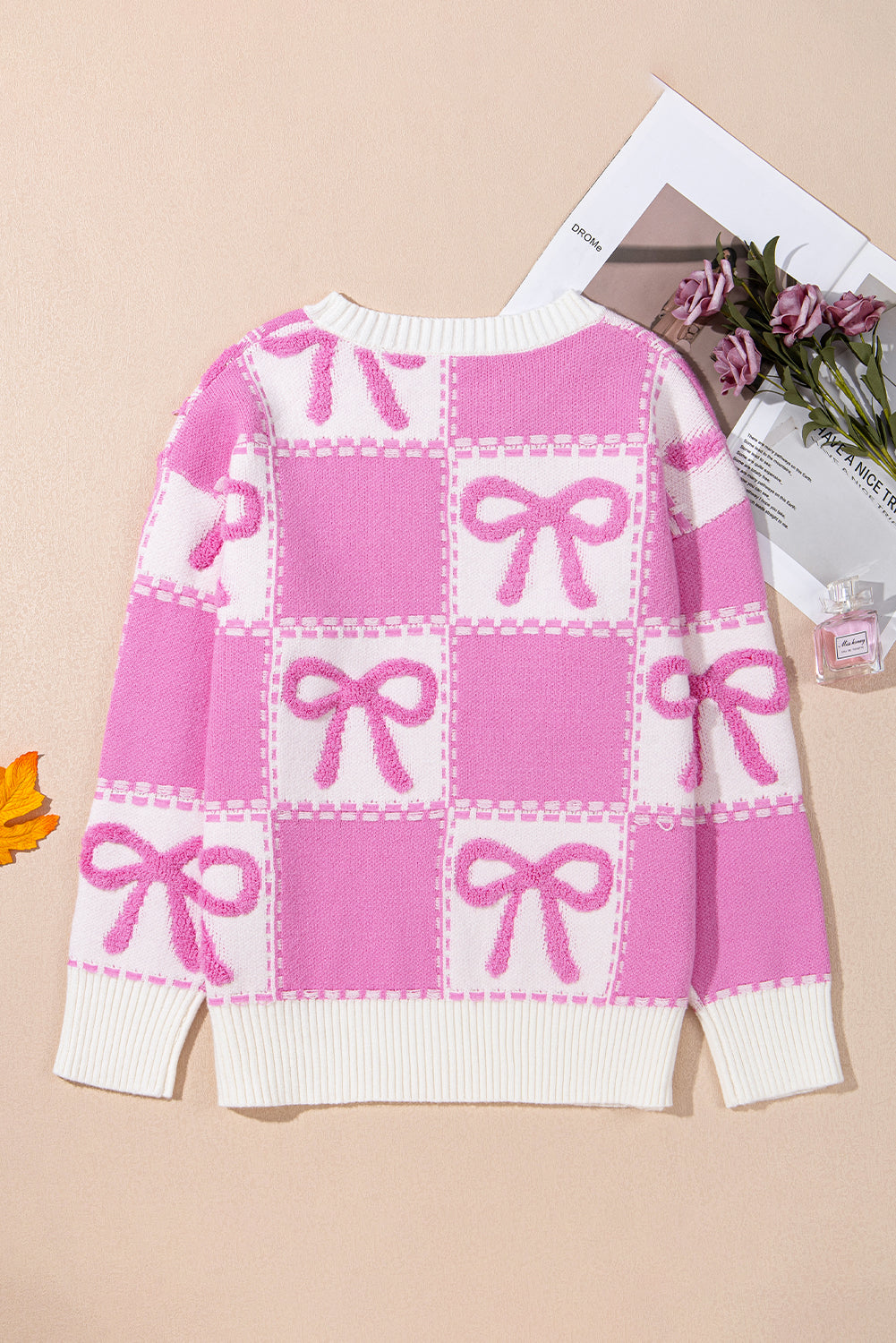 Aesthetic pink check sweater for women, stylish and cozy knitwear.
