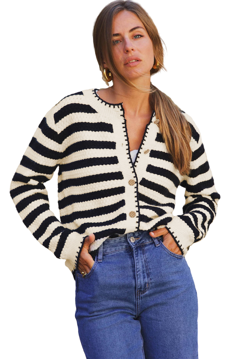 Woman wearing a black and white striped cardigan with blue jeans on a white background