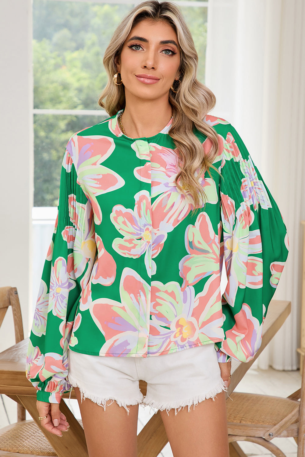 The front view of green floral blouse, featuring pleated long sleeve, round neck and front button details.