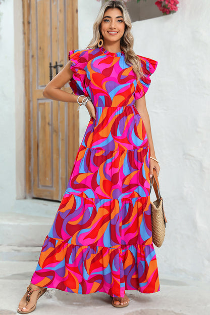 Front view of smiling model wearing tiered maxi dress with short sleeves and ruffle details.