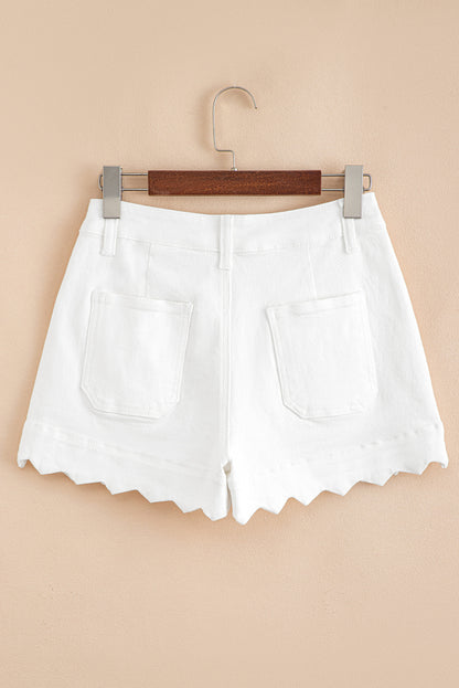 White shorts on a wooden hanger against a beige background