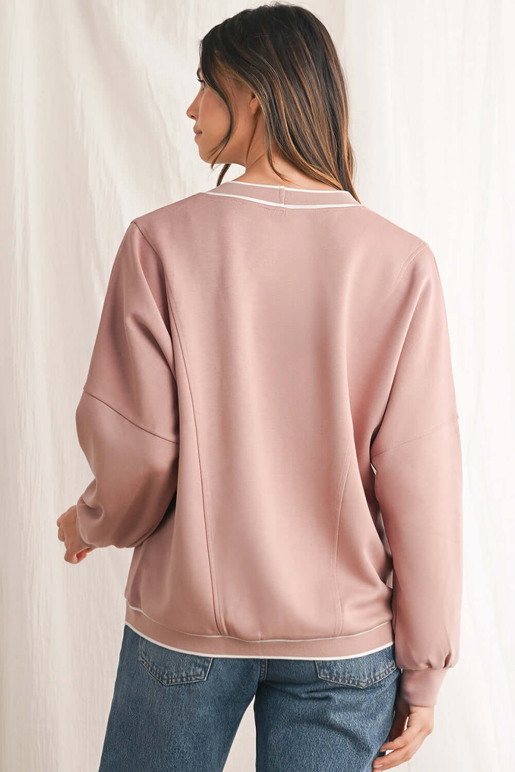 Pink striped cardigan with convenient front pockets.
