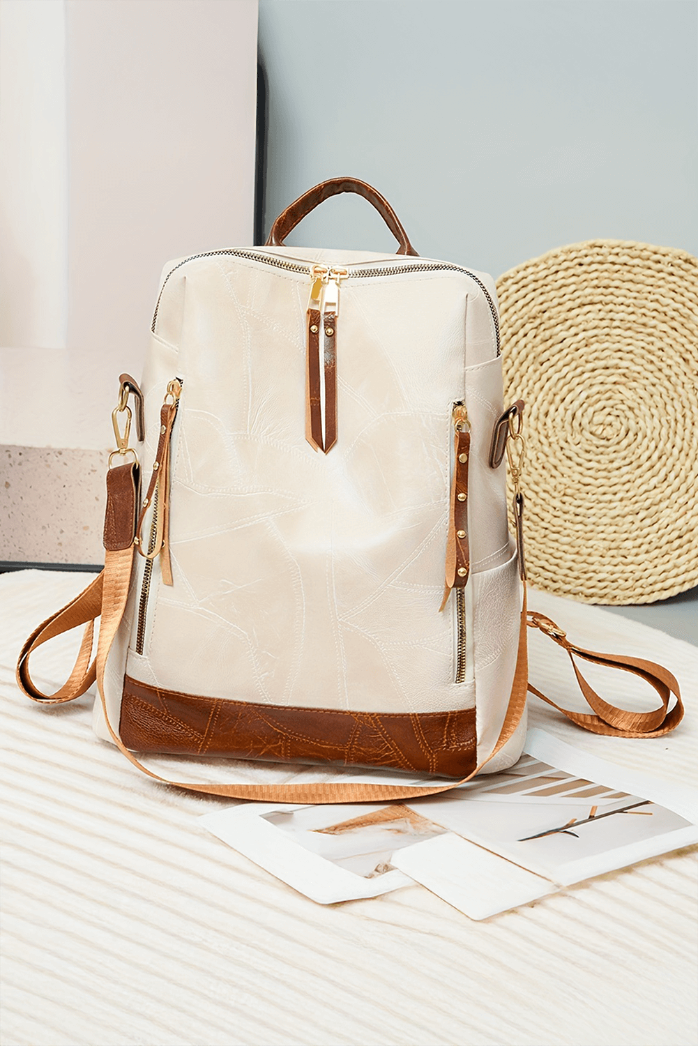 Stylish white faux leather backpack with a sleek and minimalist design