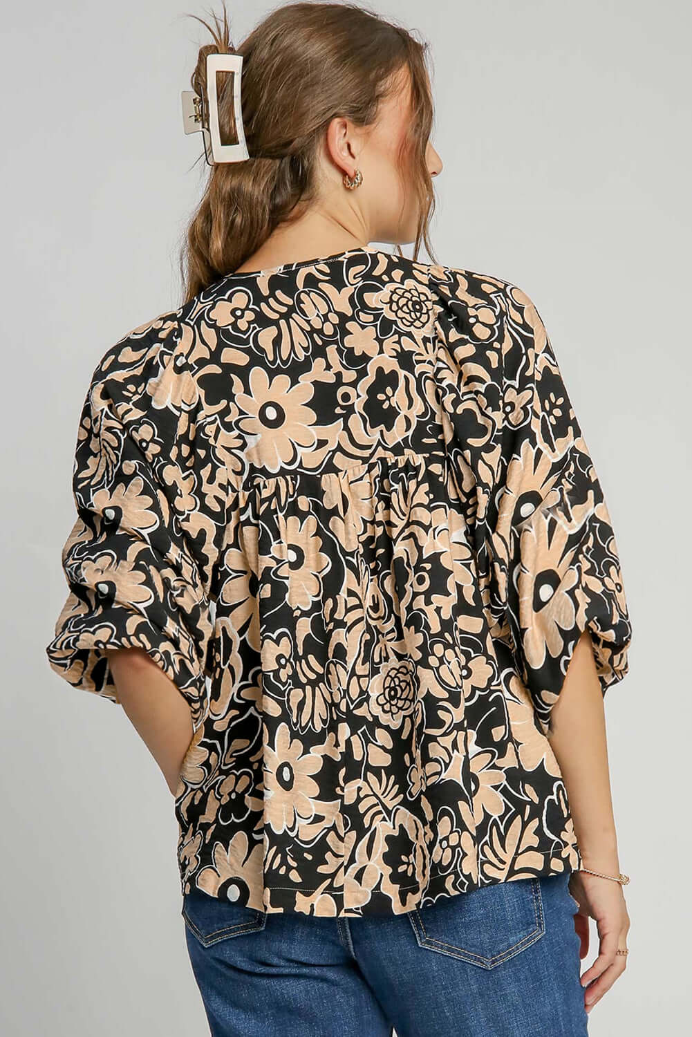 Back view of a black floral boho blouse with half sleeves, styled on a standing model, perfect for autumn and summer seasons.