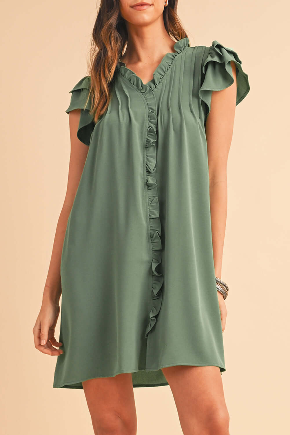 Close-up of soft ruffle trim along the front of a short sleeve dress.