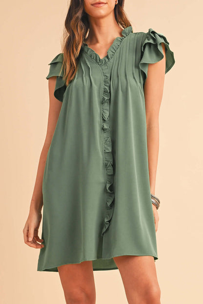 Close-up of soft ruffle trim along the front of a short sleeve dress.