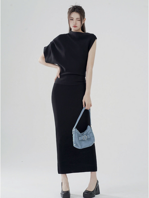 Catherine Martin black two-piece set with asymmetric batwing sleeve top and fitted midi skirt on a model