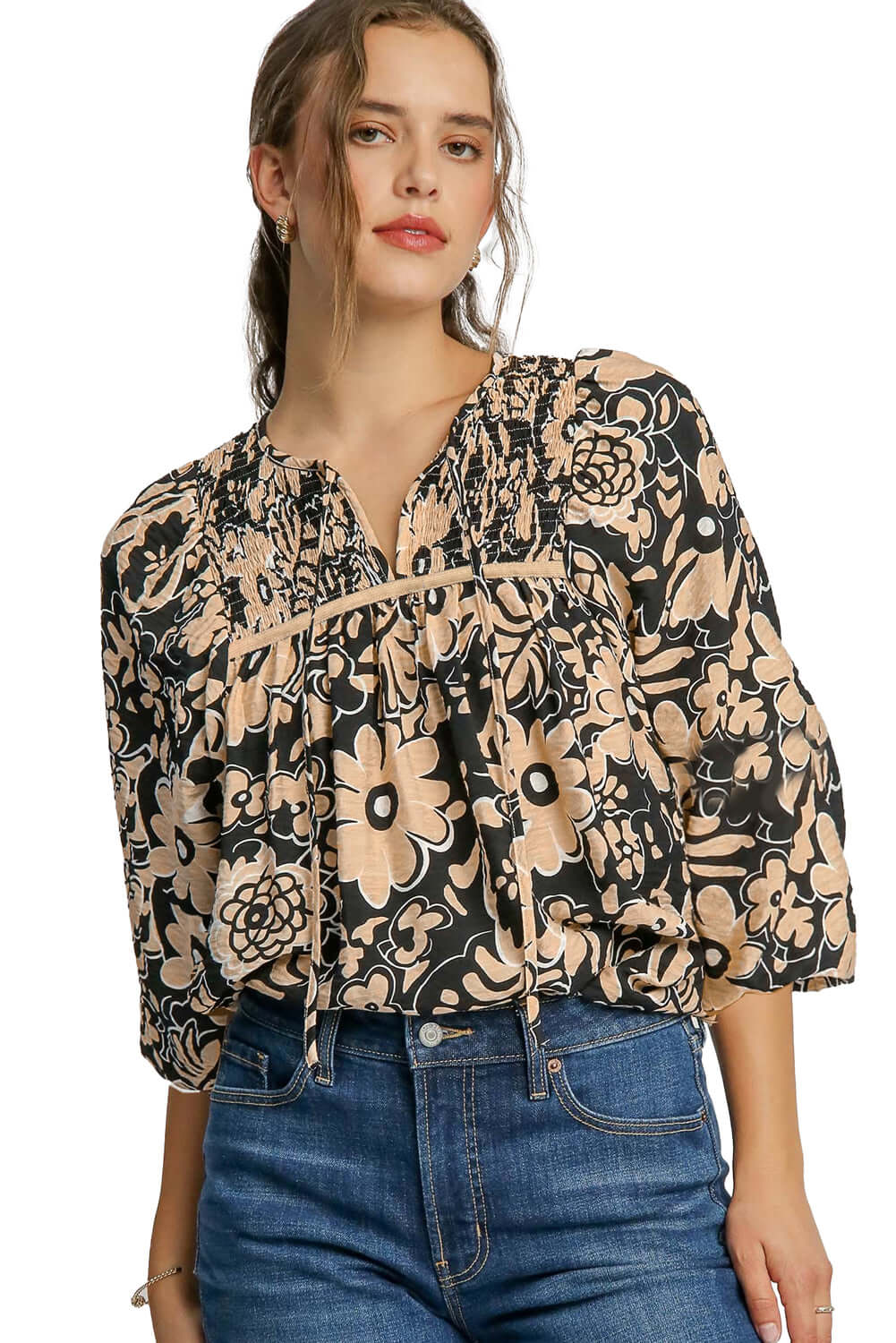 Front view of a black floral boho blouse with half sleeves, paired with blue jeans for a casual chic look, set against a white background.