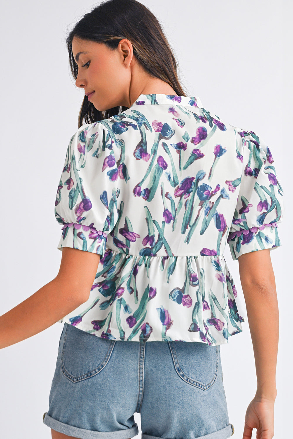 Woman wearing a floral blouse with a white background
