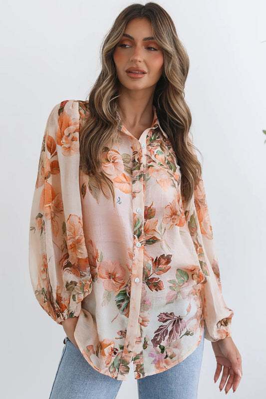 Woman wearing a floral blouse with a plain background