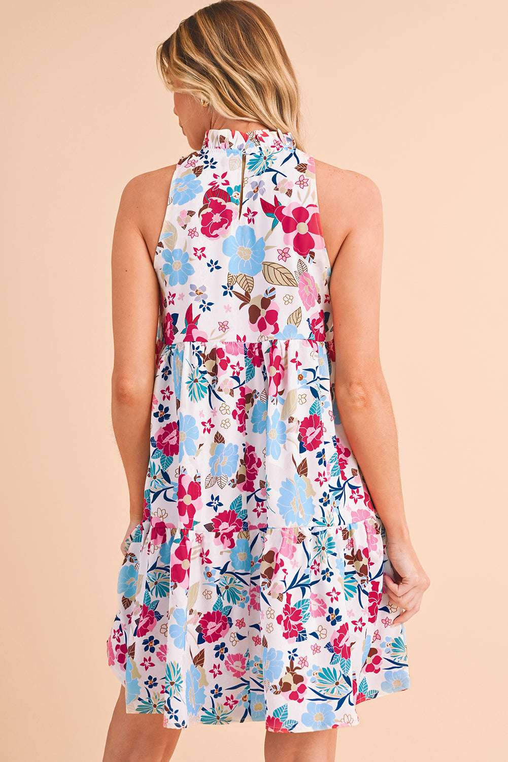 The back view of pink floral tiered mini dress, featuring sleeveless design, perfect for summer occasion. 