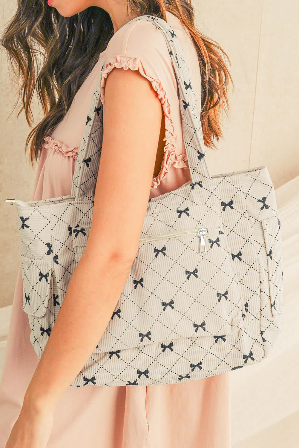 Everyday Tote with Cute Bow Print. Front view on a model's shoulder.