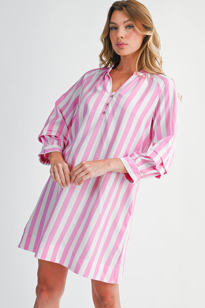 Woman wearing a pink and white striped dress on a white background