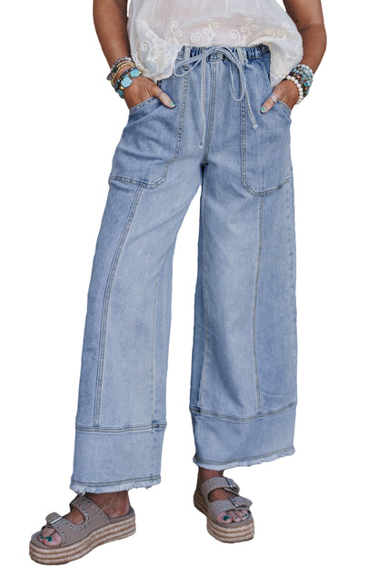 Light blue wide-leg jeans worn by a person on a white background