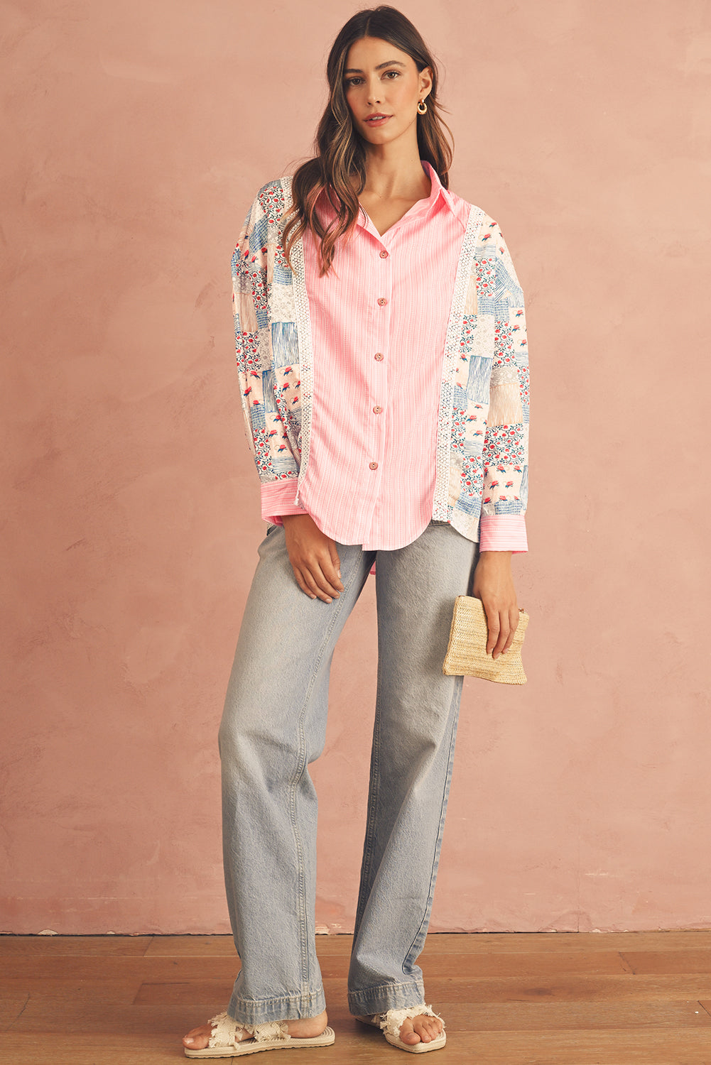 Full view of a pink floral patchwork long sleeve shirt on a model wearing jeans.