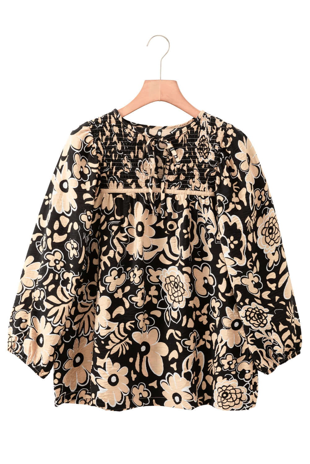 Front view of a black floral boho blouse with a lace-up split neckline and half sleeves, displayed on a hanger against a white background.