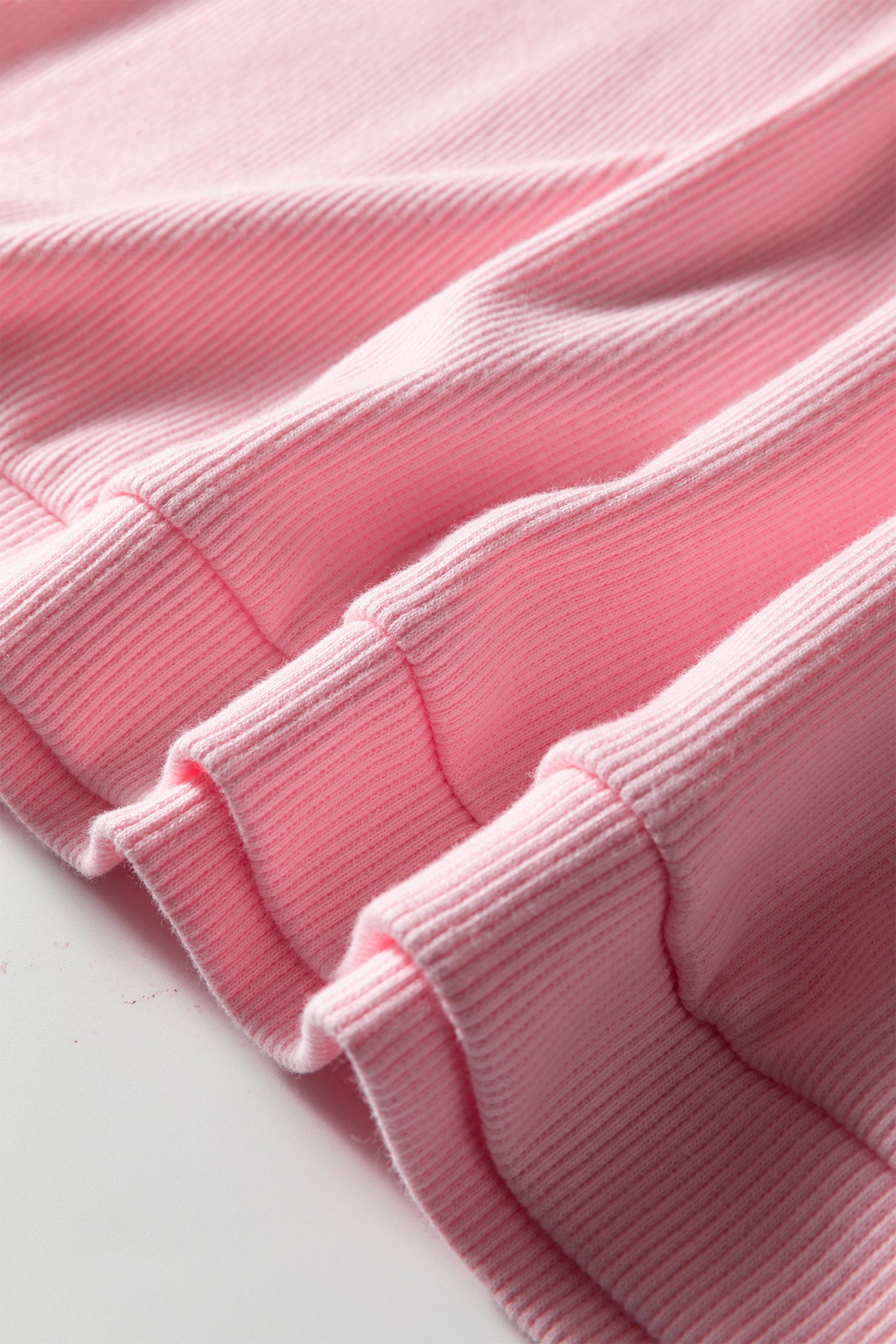 Close-up of pink textured fabric on a white background