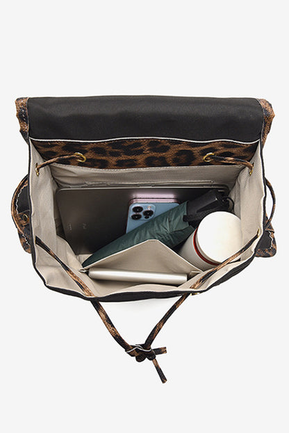 Leopard print drawstring bag with items inside on a white background
