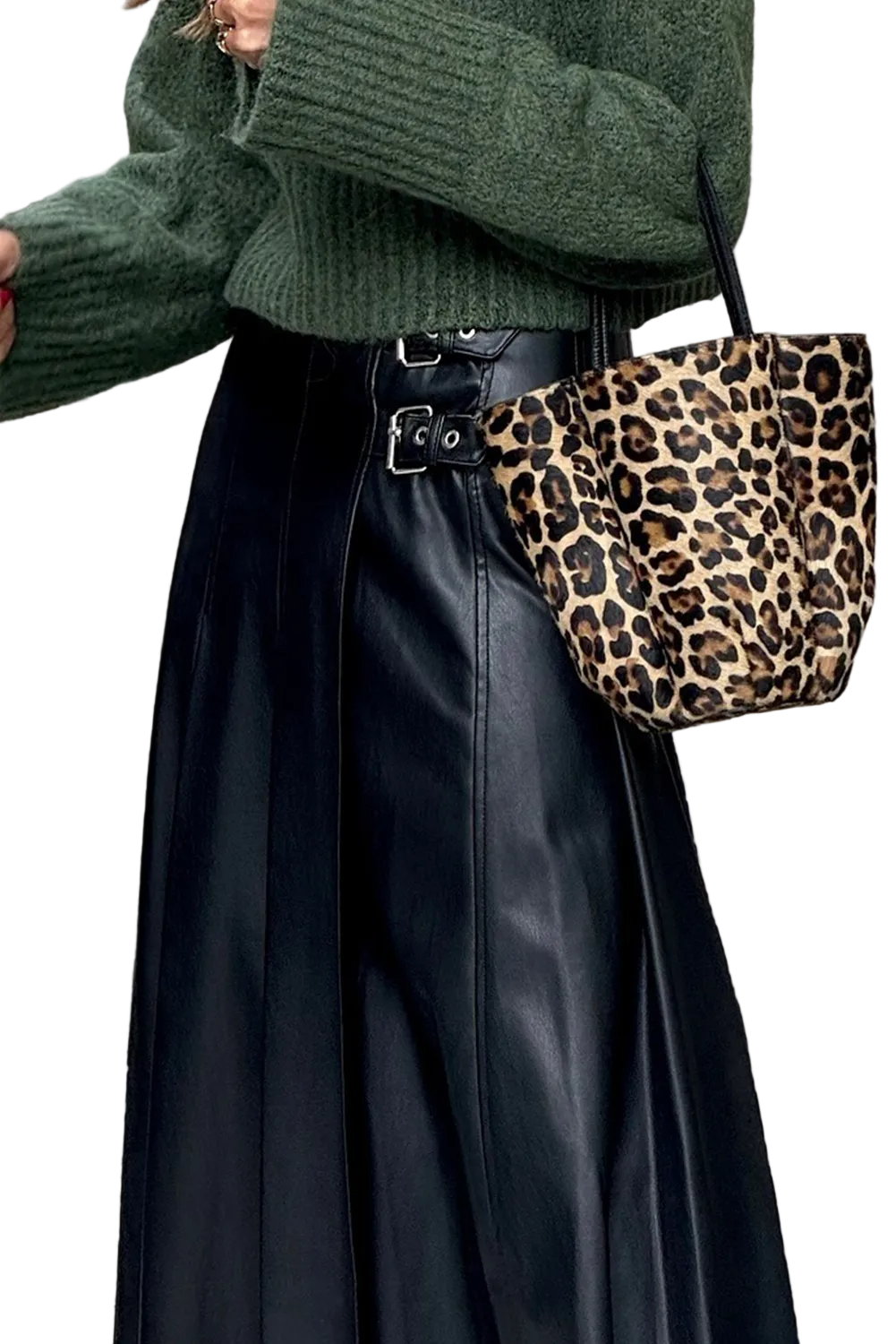 Person wearing a green sweater and black pants with a leopard print handbag.