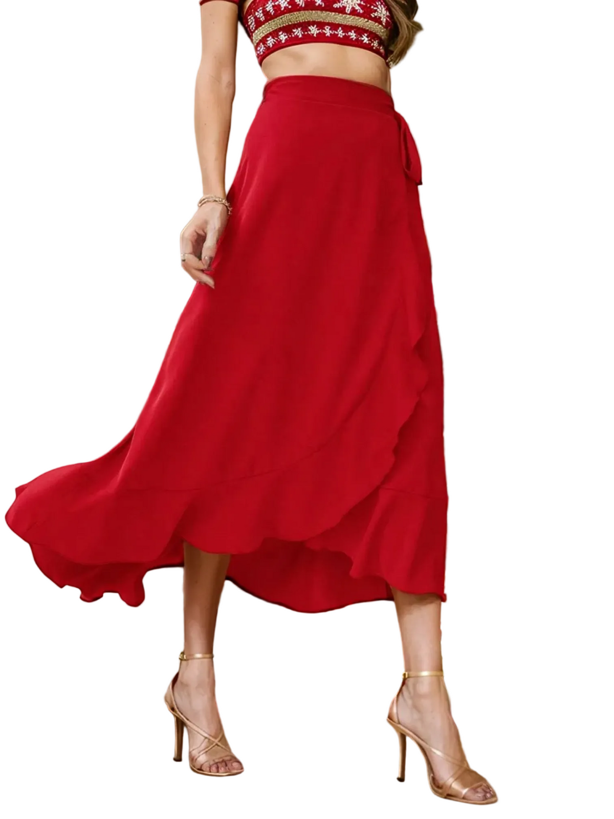 Catherine Martin red midi wrap skirt with ruffle trim and asymmetric hem worn with gold heels in a festive setting
