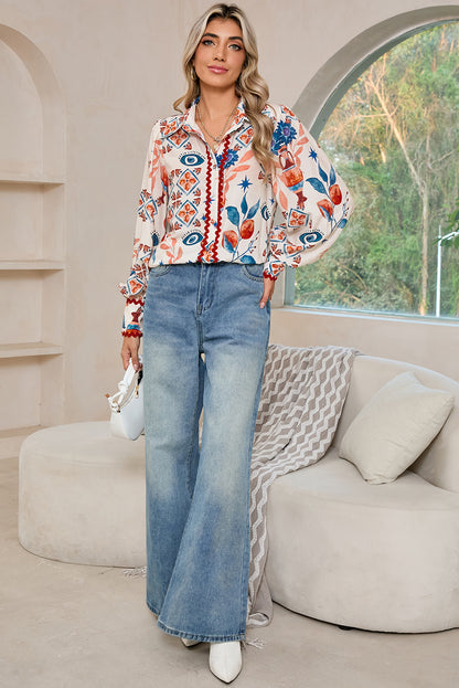 Full view of a model standing in a multicolour ethnic floral print shirt with long sleeves.