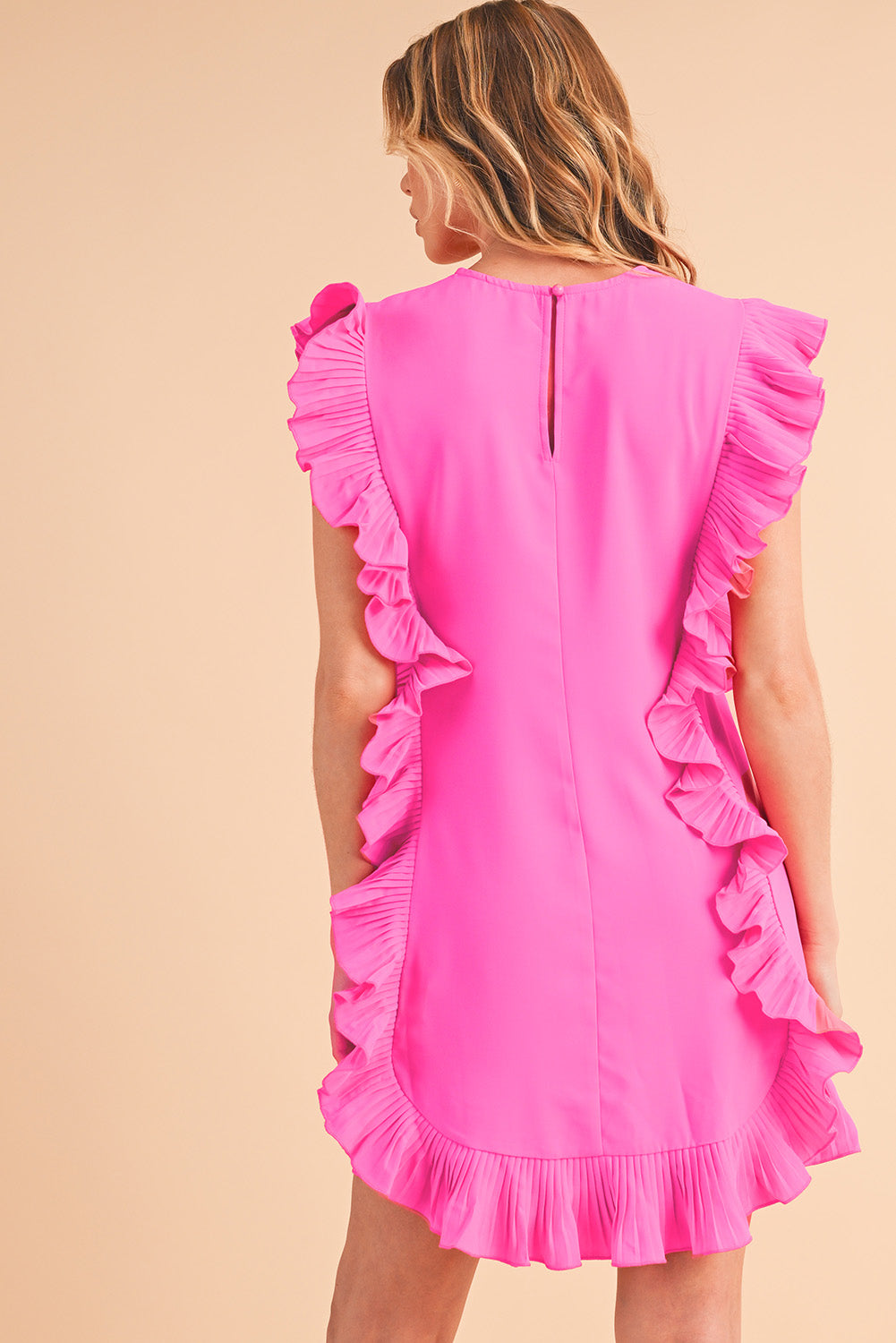 Back view of bright pink short-sleeve dress with elegant ruffle details, perfect for spring and summer special occasions.