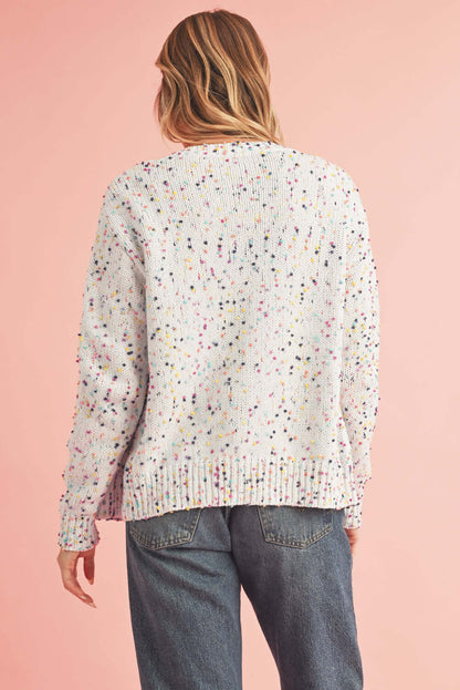 Elegant black knit cardigan with a relaxed fit and shimmering accents. Back view.
