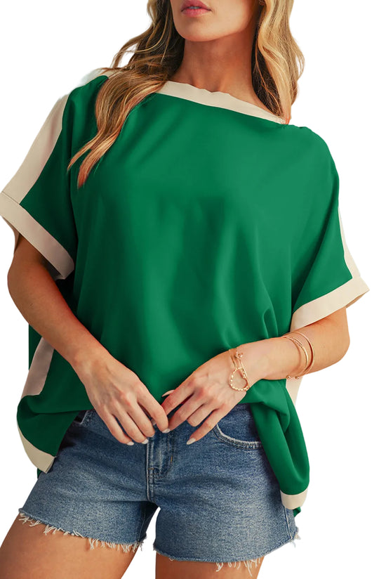 Person wearing a green and white top with denim shorts on a neutral background