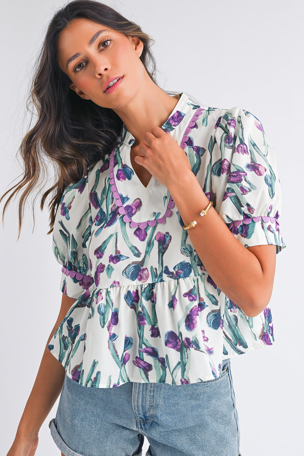 Woman wearing a floral blouse with a white background