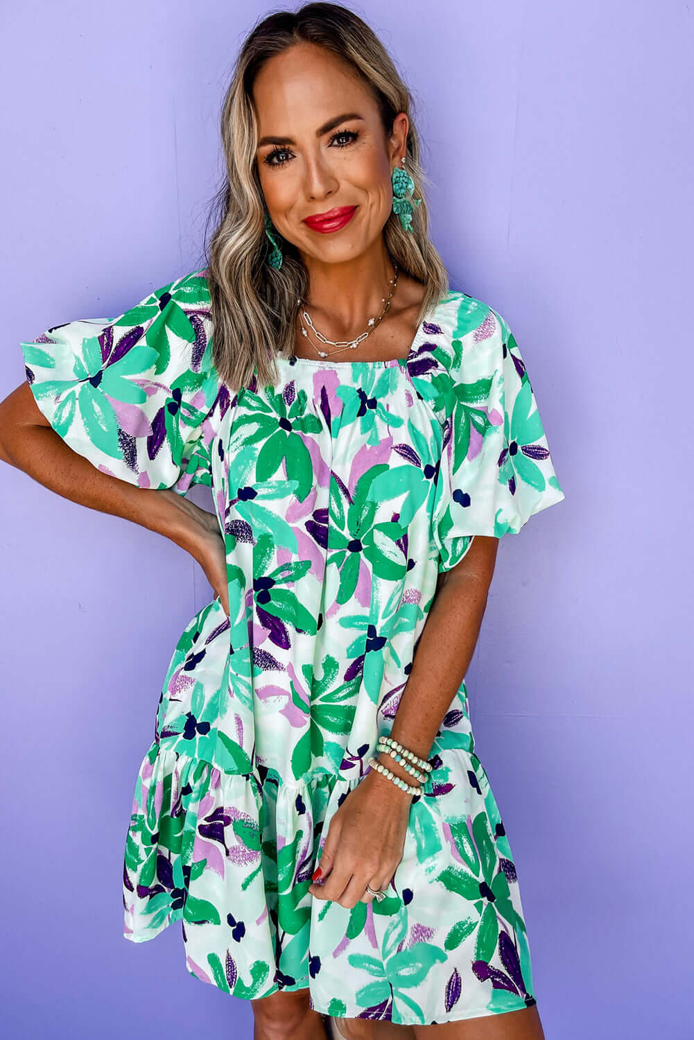 Women's green floral loose-fit dress with ruffle details.