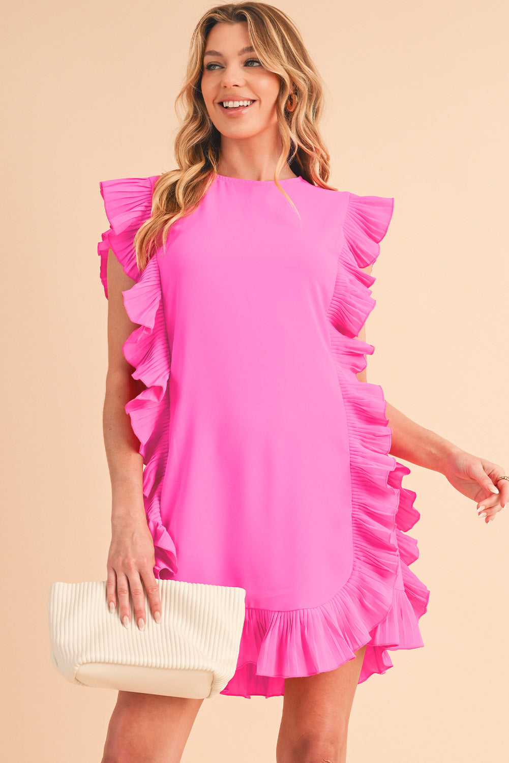 Front view of bright pink short-sleeve dress with elegant ruffle details on a smiling model holding a cream fabric clutch, perfect for spring and summer special occasions.