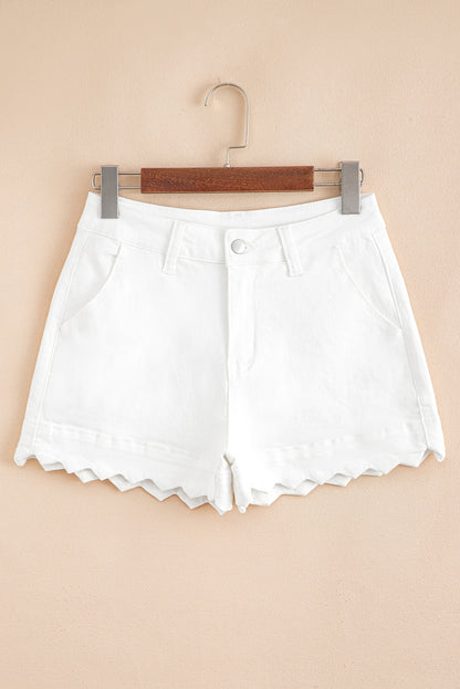 White denim shorts on a hanger against a beige background
