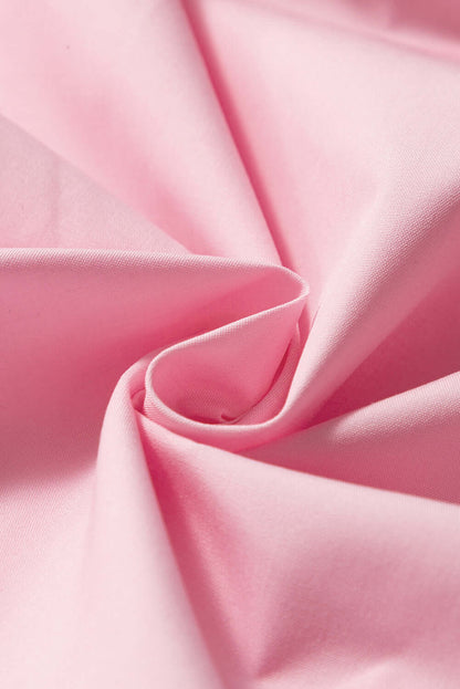 Close-up of pink tiered camisole showing delicate ruffles and breathable fabric.
