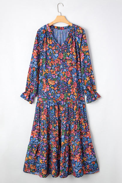 Floral dress on a hanger against a white background