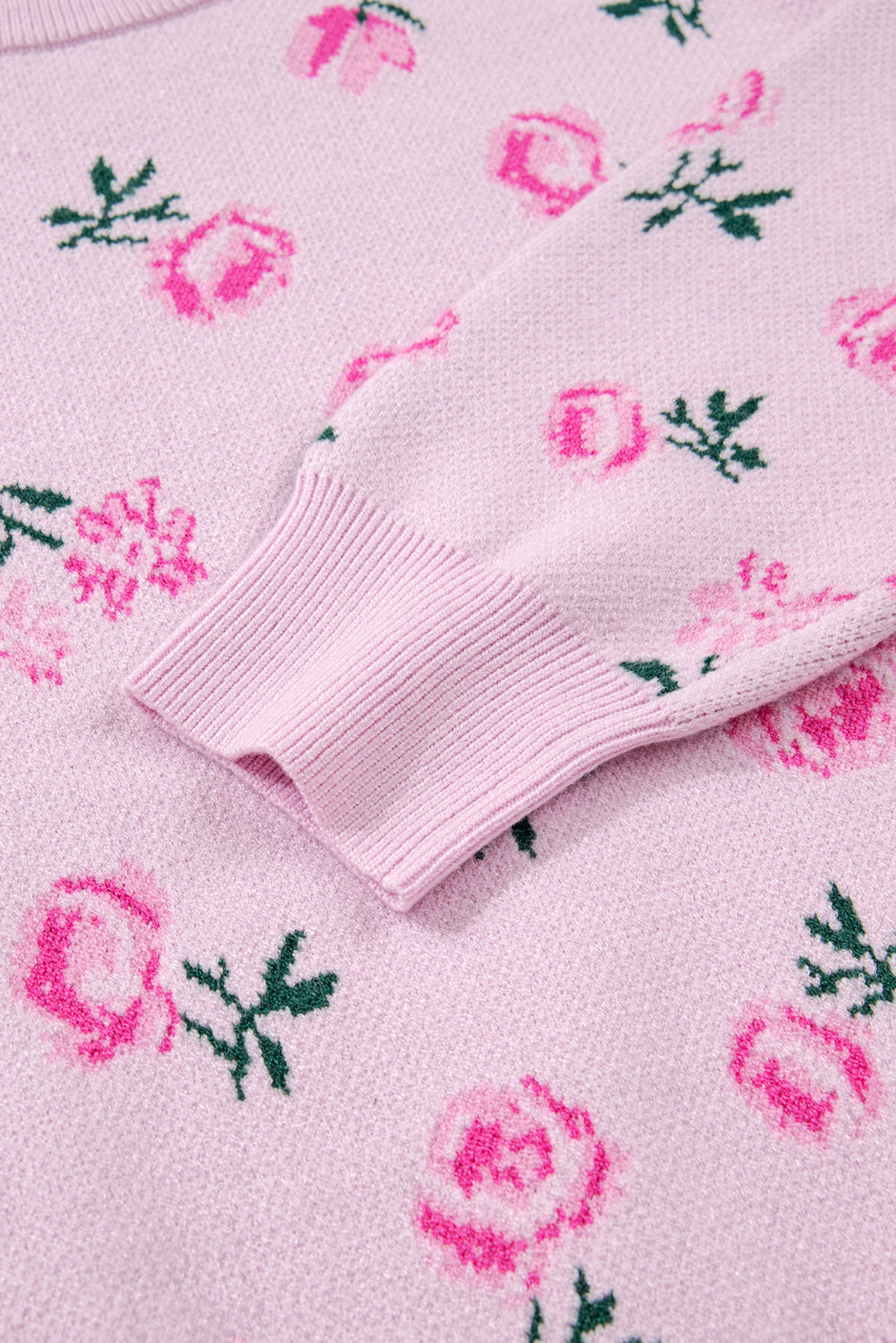Close-up of a pink sweater with floral patterns